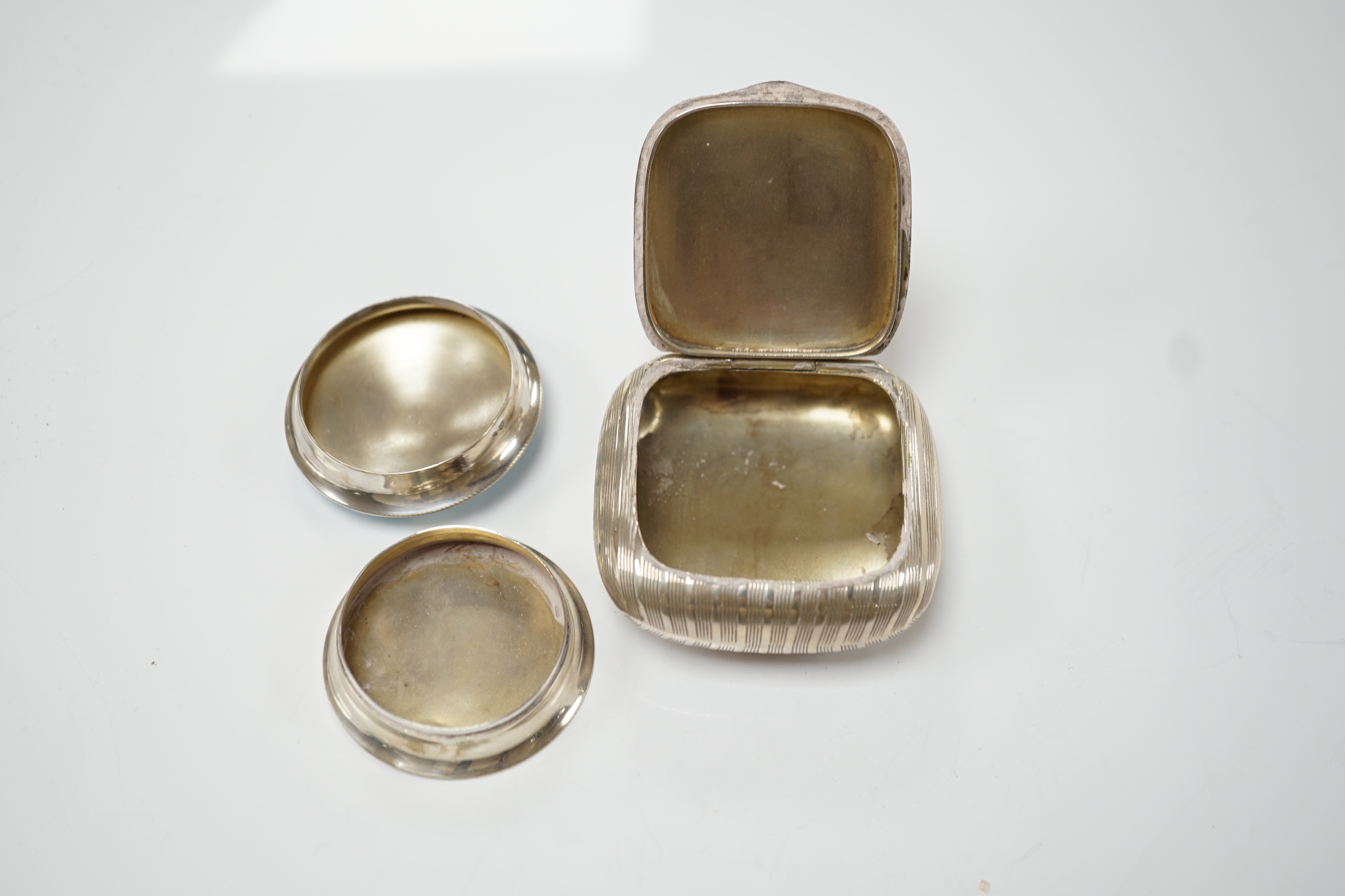 A George V silver and enamelled circular pill box and cover, Birmingham, 1910, 48mm and a German 900 standard white metal tobacco? box.